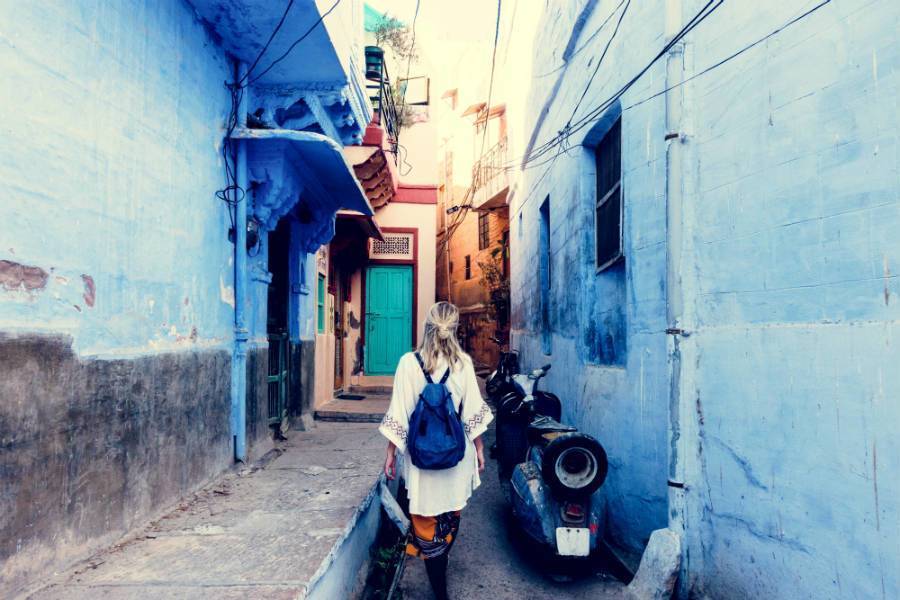 woman walks down alley while traveling