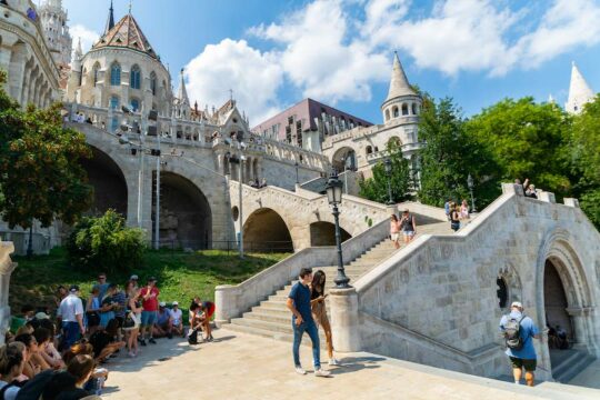 people walking down a path infront of a castle