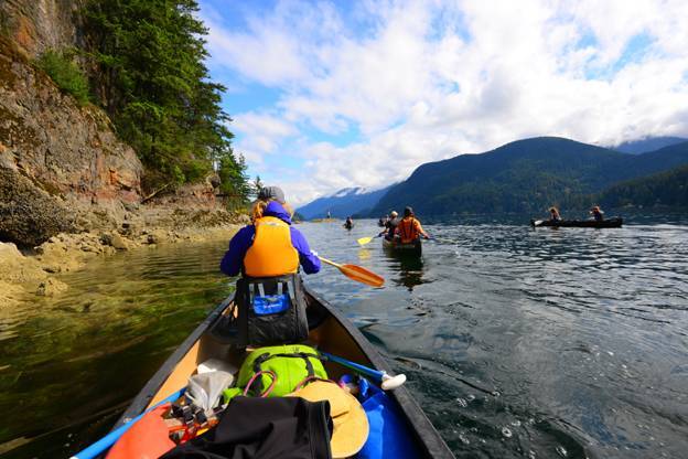 Group of kayakers going down British Columbian river