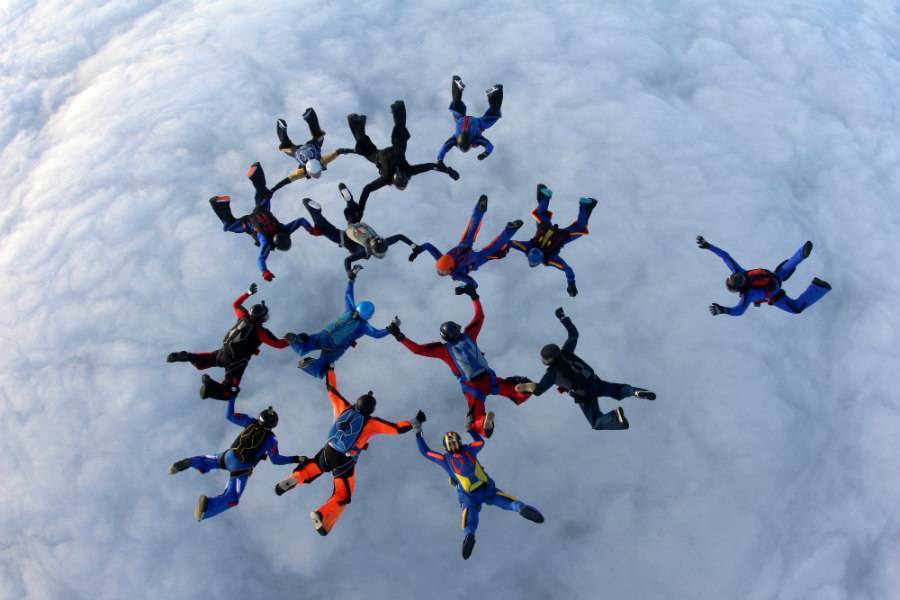 Large group of skydivers falling in formation