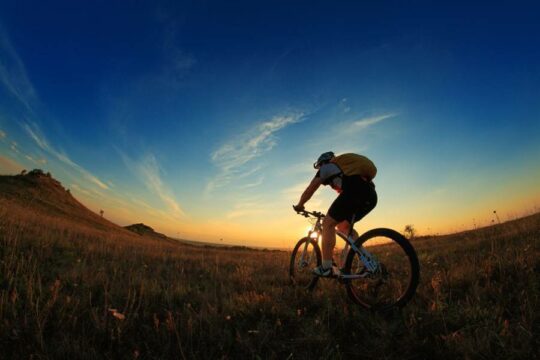 Riding a bike into the sunset