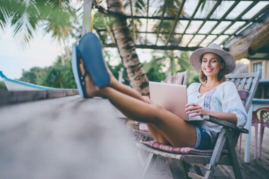 Person using a laptop on vacation