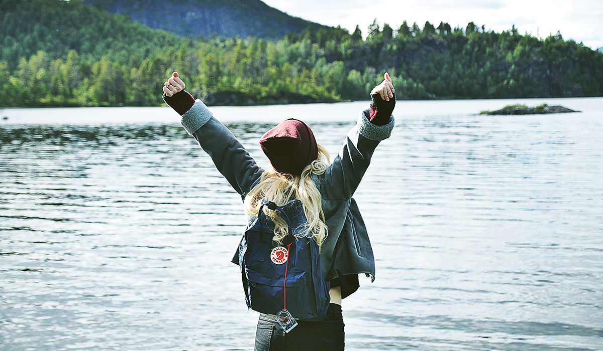 Woman stretching on the edge of a lake