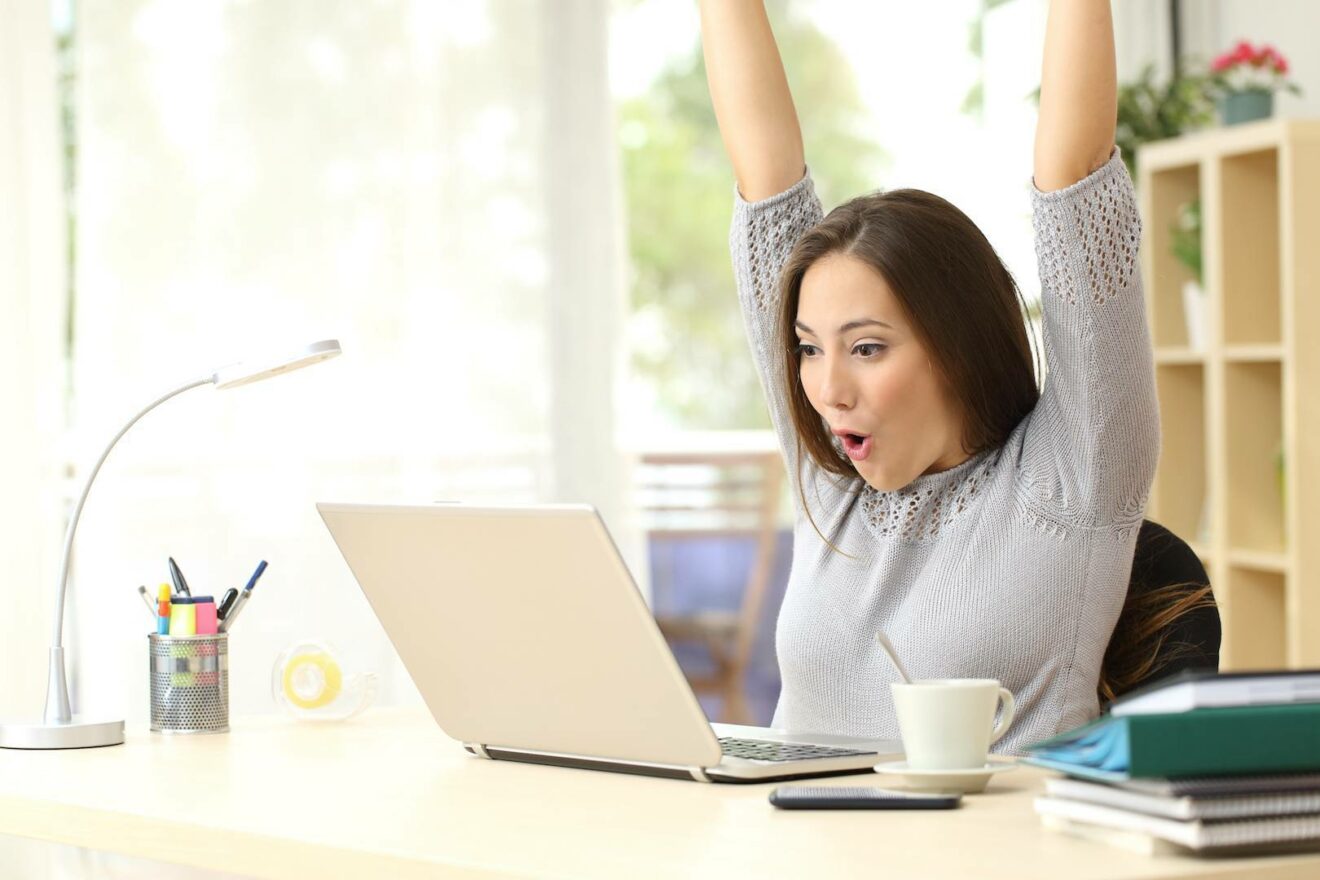 A person feeling successful at their laptop