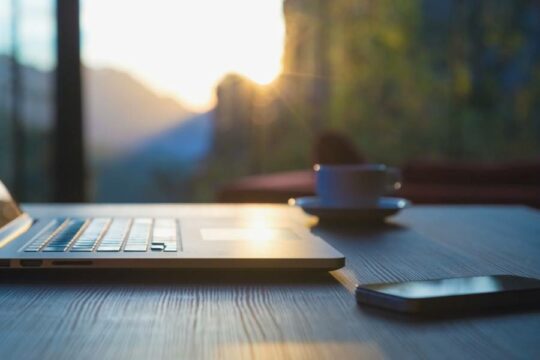 close up of laptop in front of a sunny. window