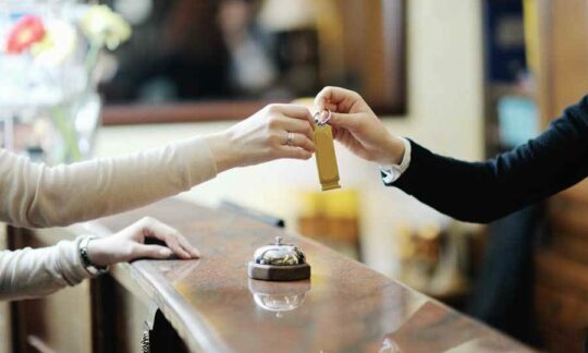 A doorman handing keys to a customer