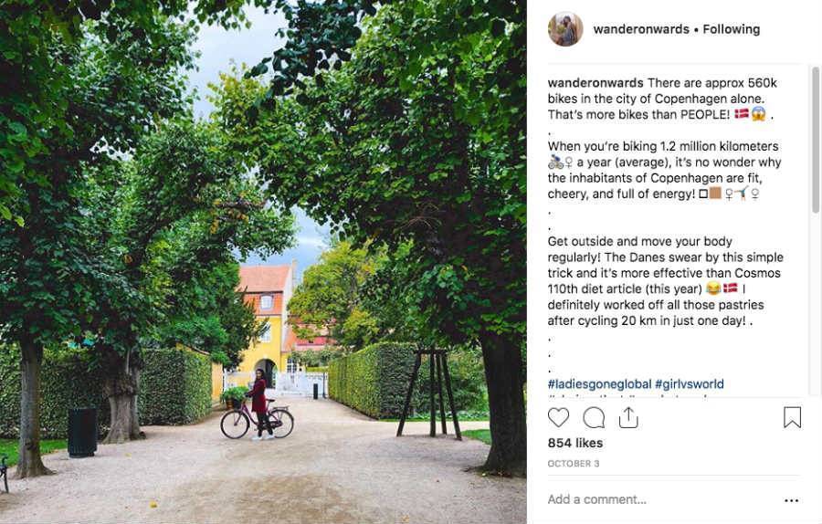 Instagram influencer marketing Vanessa of Wander Onwards on bike tour in Denmark posing underneath big trees